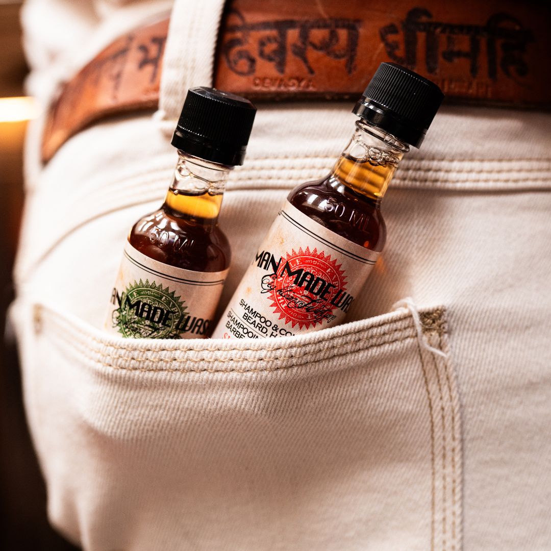 two bottles of man made wash in back pocket of jean in a lifestyle setting