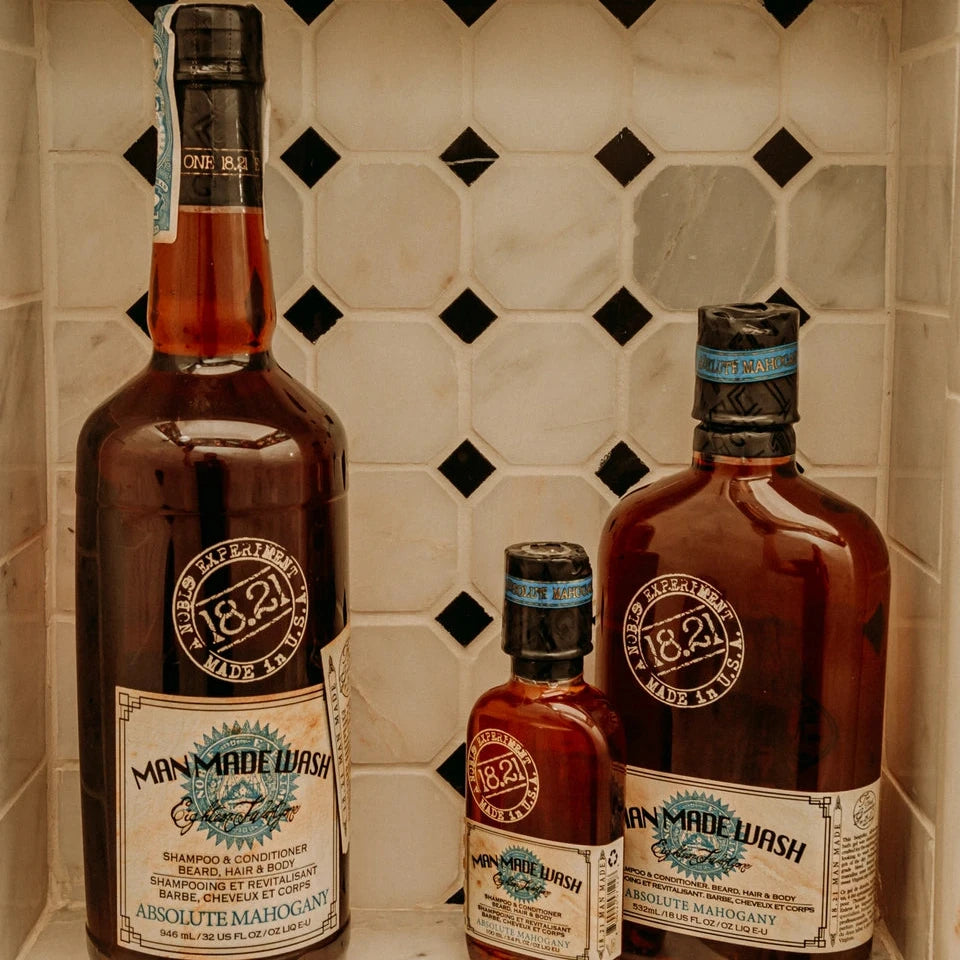 Three bottles of Manmade Wash on bathroom shelf