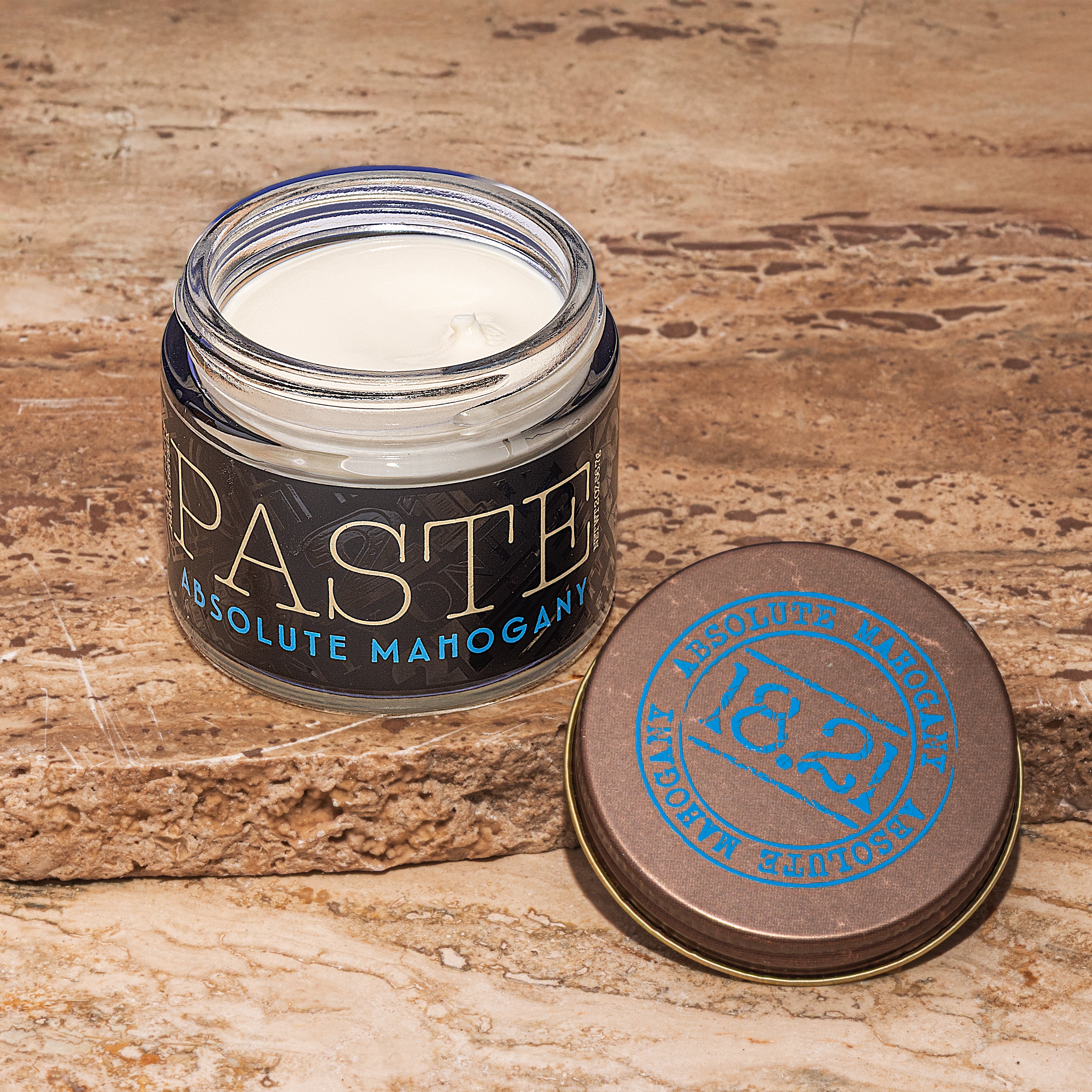 Jar of 'Paste' Absolute Mahogany paste with wooden lid on a rustic background