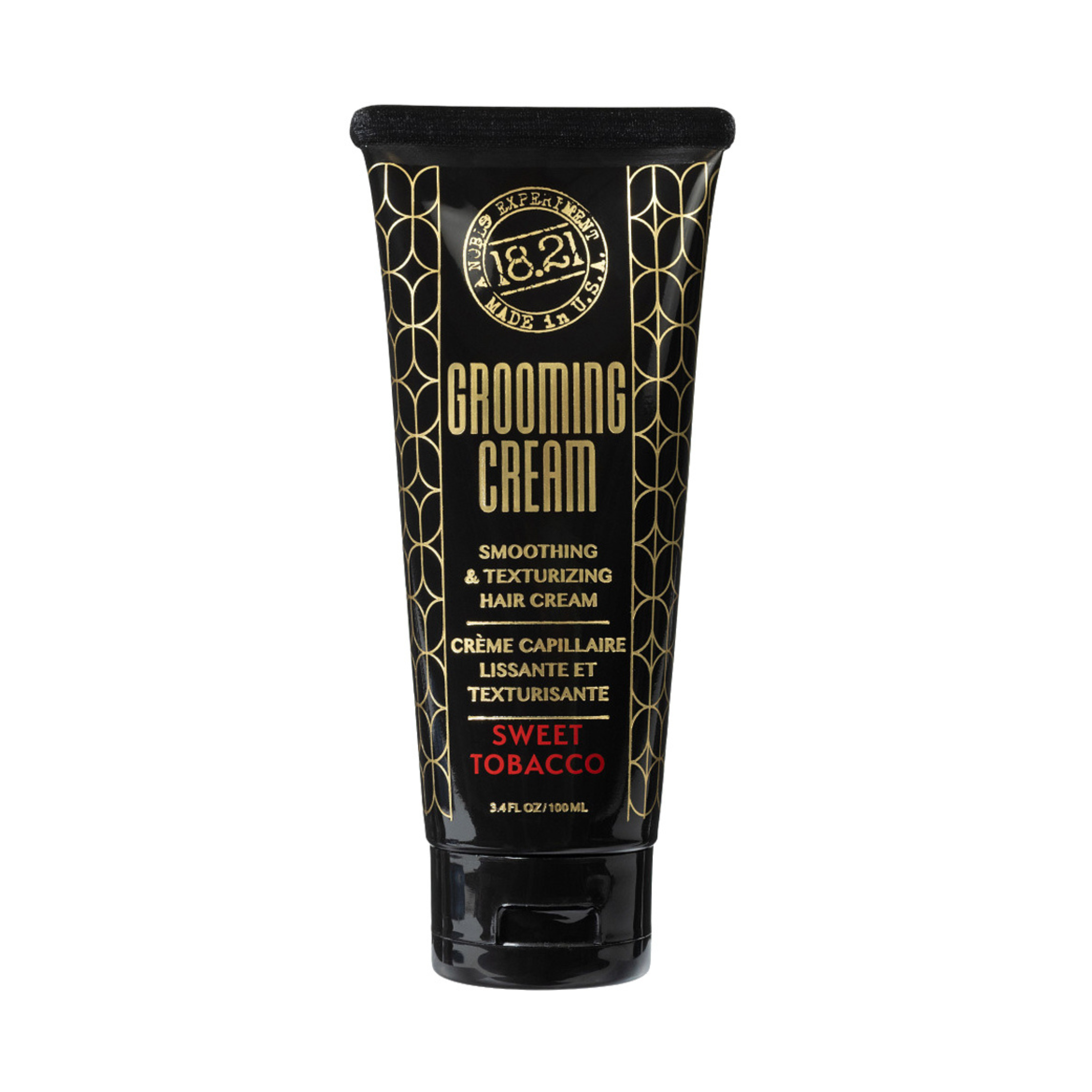 Black tube of grooming cream with gold text on a white background