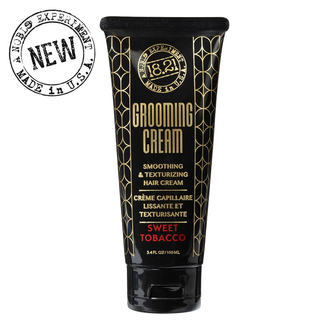 Black tube of grooming cream with gold text on a white background