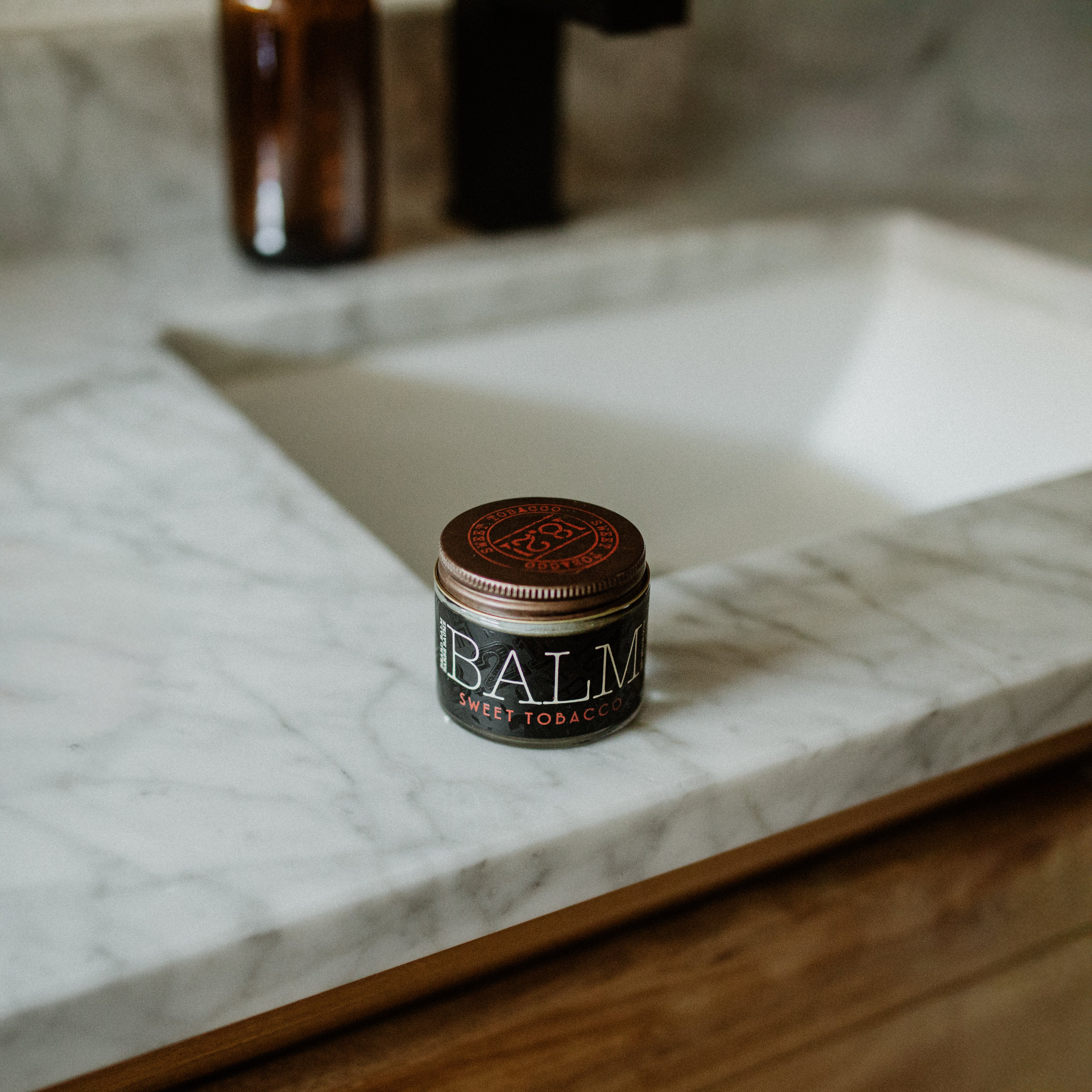 Jar of balm on a marble countertop