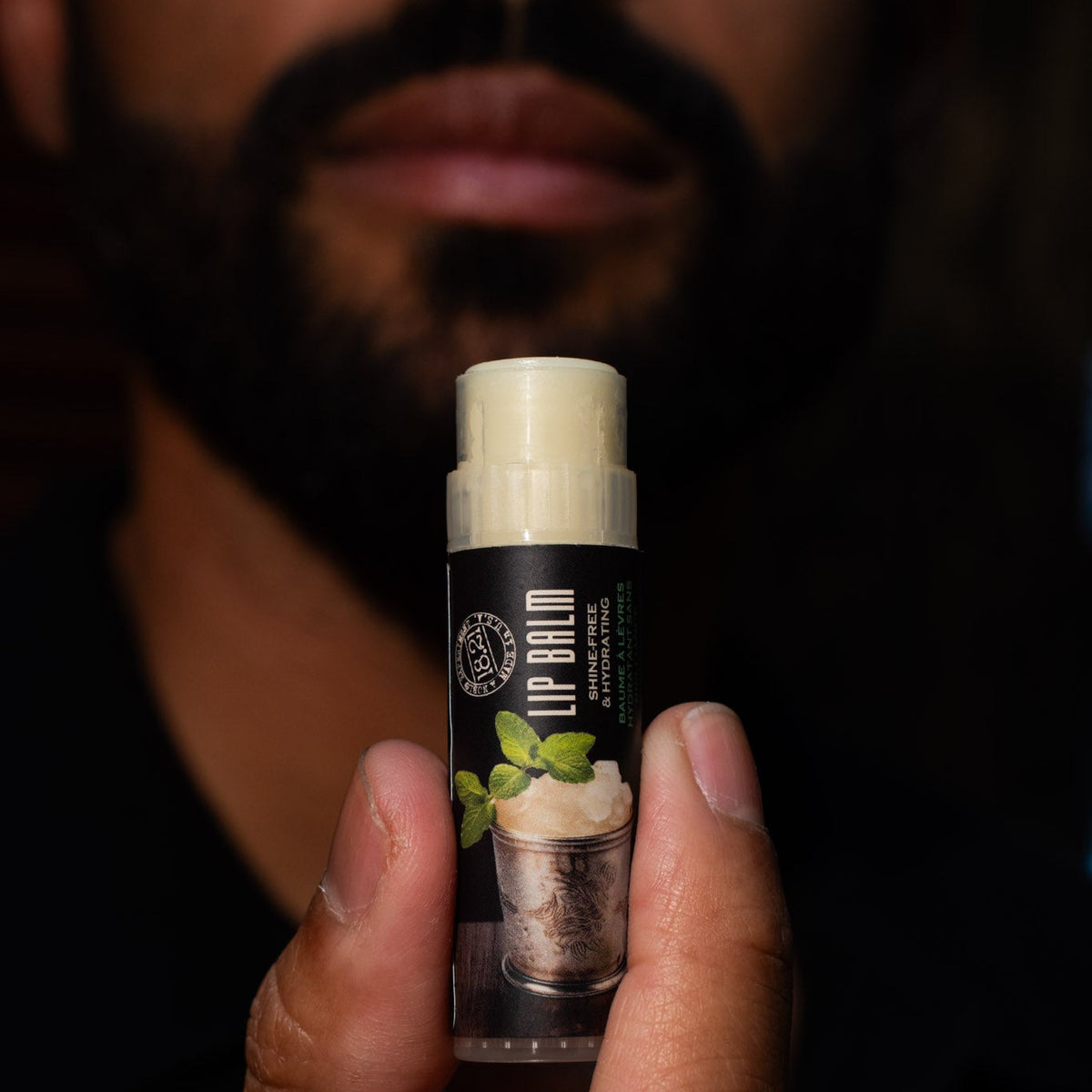 mint julep lip balm in had with person in background