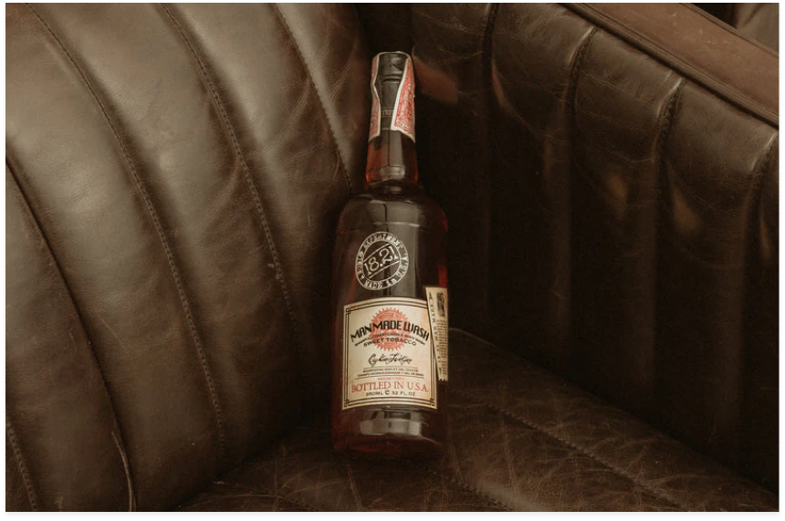 Man Made Wash bottle on a brown couch