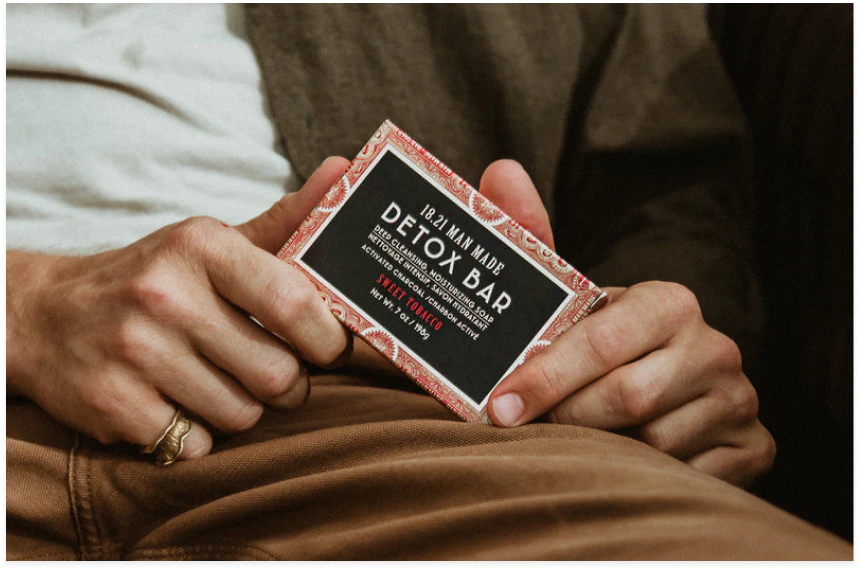 Person holding a Man Made Detox Bar wearing brown pants